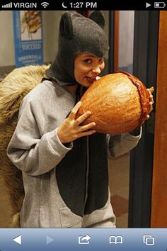 a person wearing a cat mask and holding an object