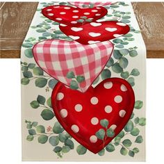 three red hearts on a white table runner