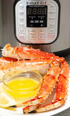 King crab legs on a serving plate with a small bowl of butter and a lemon wedge siting in front of an Instant Pot. Fancy Seafood Dinner, Fancy Seafood, Steamed Crab Legs, Power Pressure Cooker Xl Recipes, Steamed Crab, Cooking Crab Legs, Cooking Crab, Crab Legs Recipe, Steamed Crabs