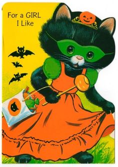 a halloween card with a black cat wearing an orange dress and holding a candy bar