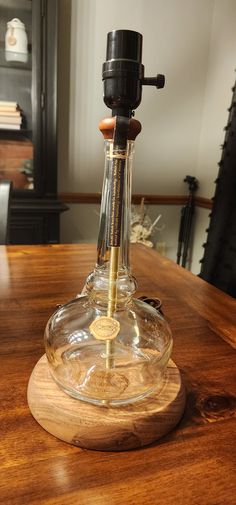 an old fashioned decanter is sitting on a wooden table