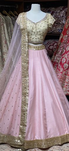 Ballerina pink skirt with gold sequins lace border teamed with contrasting gold floral zardozi, cut dana and stone work blouse and net dupatta. Fabric: Raw Silk This outfit can be customized in multiple colors and specific to client measurements. 90 days of production time is required and are for bulk orders only! Orders are processed in store only! Final fittings/alterations not included. Minimum Order Quantity- 4 pieces Embellished Tissue Silk Lehenga For Festivals, Raw Silk Wedding Dress With Gota Work, Wedding Dresses In Raw Silk With Gota Work, Raw Silk Dress With Gota Work For Wedding, Bollywood Style Embellished Tissue Silk Lehenga, Pink Raw Silk Sharara With Zari Work, Pink Raw Silk Sharara With Gota Work, Pink Raw Silk Set With Sheer Dupatta, Pink Raw Silk Sharara For Navratri