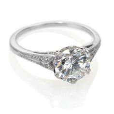 an engagement ring with a diamond on the front and side, in white gold or silver