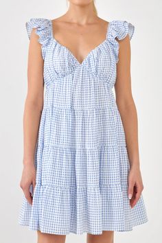 Get ready to look pretty in pink with this Gingham Printed Tiered Mini Dress. With ruched sweetheart neckline, ruffled shoulders and a tiered bodice, this dress is sure to make you stand out in a crowd. The flounce and lined skirt make this dress even more feminine and sweet. And with a side invisible zipper closure, t Pink Gingham Dress, Sadie Hawkins, Faux Shearling Vest, Knit Loungewear, Faux Shearling Jacket, Strapless Bodycon Dress, Tiered Mini Dress, Shearling Vest, Roller Rabbit