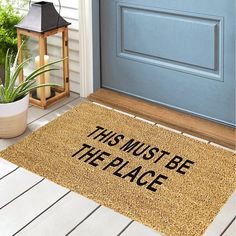 a door mat that says, this must be the place next to a potted plant