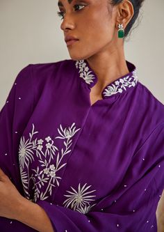 The garment is made in crepe, with parsi gaara embroidery patterns designed, embroidered and embellished with mirrorwork in house, and styled by the designers at our studio with the finest details. Floral Cape, Purple Cape, Nyc Studio, Cape Jacket, Jacket For Women, Short Suit, Floral Motifs, Bride Bridal, Mandarin Collar