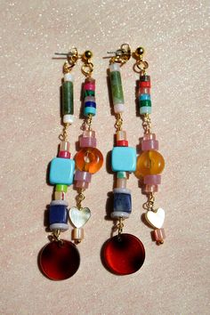 Get ready to have some fun with these playful, beaded ear jackets! Filled with bold colors, funky natural stones, and cute little details like hearts and tortoiseshell charms. On top of that these earrings are even cooler because they are like two in one! They will dangle in your ear in such a unique way. Whether you’re dressing up or keeping it casual, these earrings will add a pop of personality to any look. We created them in a rainbow color combination and in a fall inspired color palette wi Cozy Glam, Fall Tones, Hoop Charms, Color Ways, Stacked Earrings, Funky Earrings, Ear Jacket, Earrings Inspiration, Funky Jewelry