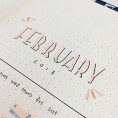 the word february written in cursive writing on top of a page of paper