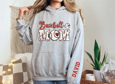 This customizable Baseball Mom hoodie comes in several colors and makes the perfect gift for mom! College Team Name Hoodie For Baseball Season, College Hoodie With Team Name For Baseball Season, College Hoodie For Baseball Season With Team Name, College Team Hoodie For Baseball Season, Casual Personalized Hooded Hoodie, Baseball Season Fan Apparel Hoodie For Sports Events, Casual Personalized Crew Neck Hoodie, Athletic Heather Hoodie With Letter Print For Sports, Customizable Casual Sports Hoodie