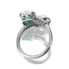 Toi et Moi Engagement Ring with Old European Cut Diamond and Colombian Emerald The Evora ring is a remake of an authentic vintage diamond and emerald ring from the Art Deco Era circa 1920. The ring features a GIA-certified 1.46-carat Old European Cut diamond of I color, I1 clarity and a GCS-certified 1.12-carat Octagonal Cut Colombian emerald of minor clarity enhancement. On either side of the center stones are eight Old European Cut diamonds of approximately H-I color, totaling approximately 0.16 carats. The stones are set in a platinum setting. The ring is currently size 6 and can be resized! Why We Love It This ring was originally an antique piece but the ring itself wasn't sturdy enough for daily wear. So, we took the stones out and remade the ring with the same stones and same design Gia Certified Oval Emerald Ring In Art Deco Style, Art Deco Oval Emerald Ring With Brilliant Cut, Heirloom Emerald Diamond Ring For Formal Events, Platinum Oval Emerald Ring With 17 Jewels, Oval Platinum Emerald Ring With 17 Jewels, Hallmarked Oval Emerald Ring In Platinum, Oval Hallmarked Emerald Ring In Platinum, Platinum Emerald Ring In White Gold, Heirloom Emerald Ring Gia Certified