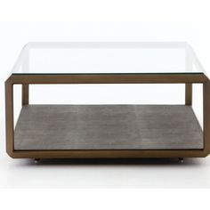 a coffee table with a glass top and metal frame on the bottom, in front of a white background