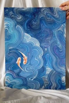 two orange koi fish swimming in blue water with swirly clouds and white background