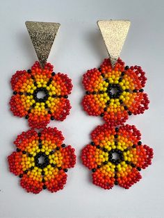 "We absolutely love these easy-to-wear charming Flower Bead earrings that are the perfect piece of summer jewelry. These vibrant earrings are a perfect eye-catching piece needed to complete your look.  The earrings were handmade using ancestral beading techniques. Color: Red, Yellow, Orange, & Red  Metal: Bronze  Metal Color: Gold Size: 3.4\" L x 1.4\" W Check out other similar products in our store and visit us at: https://www.etsy.com/shop/Eklectyc" Orange Beaded Flower Earrings, Beaded Teardrop Flower Earrings As Gift, Beaded Teardrop Flower Earrings For Gift, Adjustable Flower-shaped Earrings With Colorful Beads, Adjustable Flower Shaped Earrings With Colorful Beads, Colorful Beads Flower Shape Earrings, Adjustable Colorful Beaded Flower-shaped Earrings, Flower Shaped Dangling Beads Earrings For Festivals, Flower-shaped Earrings With Tiny Beads For Gift