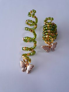 Beaded loc coil made with 4mm green and gold glass seed beads, and gold butterfly charm on brass coil. Fits small to medium locs or braids, hole size 7 to 9mm. Sold individually. Loc Charms Dreadlock Accessories, Butterfly Locs With Beads, Loc Jewelry On Short Locs, Loc Decoration, Locs With Shells, Locs With Accessories, Hair Charms For Braids, Short Locs With Beads, Raindrop Braids