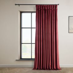 a red curtain hanging on the side of a window in front of a white wall