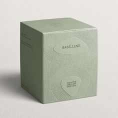 A cardboard soft green tea box with an embossed line pattern inspired by Kyoto gardens. It features the company, Baseline, logo and product description inside a pebble shape. Matcha Packaging, Mises En Page Design Graphique, Visuell Identitet, Cosmetic Packaging Design, Perfume Packaging, Cosmetic Design