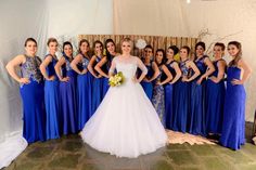 a bride and her bridal party posing for a photo in front of a backdrop