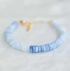 "This gorgeous ombre blue opal is available in the following options: #1 Clasp bracelet -size is adjustable 6-8\" -14K gold filled clasp and extender -lobster clasp #2 -stretch bracelet -14K gold filled accent *measure wrist and add 1/2\" to determine bracelet size *made in Vancouver, gemstones are 100% genuine NATURAL un-dyed opal Q U A L I T Y  The upmost quality and care goes into sourcing each and every material I use. Gemstones are sourced from Jaipur and Rishikesh, India and I hold stronger connections to my suppliers. I use 100% authentic gemstones, this is our guarantee (no synthetics or imitation stones).  HANDMADE with love and care by me in my studio in Halifax, NS (Canada) △View my entire shop here: www.etsy.com/ca/shop/EarthlyAbundanceGems G I F T I N G  Your bracelet will arr Larimar Bracelet, Rishikesh India, Gemstone Properties, Cotton Gift Bag, Bracelet Dainty, Clasp Bracelet, Rishikesh, Chain Extenders, Opal Bracelet