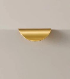 an image of a gold door handle on a white wall