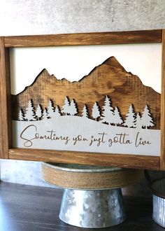 a wooden frame with the words something you just got to love on it and some trees in the background