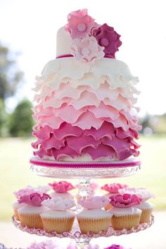 a three tiered cake with pink and white ruffles