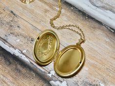 This gold oval locket necklace is a great keepsake necklace. It opens for your favorite two photographs. You will need to find a photo that fits and glue it into place. We do not place the photo in for you and at this time we do not engrave. It's the perfect gift for all ages. These lockets are not vintage, they are new. Unfortunalty it is very difficult to find vintage lockets. I T E M • DETAIL: - PENDANT SIZE: Outside measurements 7/8" x 1 1/4", Inside measurement 5/8 x 7/8 - CHAIN LENGTH: 16" Gold Oval Pendant Locket Necklace For Personalized Gift, Gold Oval Locket Necklace For Personalized Gift, Oval Gold Locket Necklace For Personalized Gift, Gold Oval Locket Necklace For Keepsake, Personalized Gold Locket Necklace With Oval Pendant, Cameo Oval Pendant Locket Necklace Gift, Cameo Locket Necklace As Gift, Oval Cameo Locket Necklace Gift, Oval Pendant Locket Necklace For Keepsake