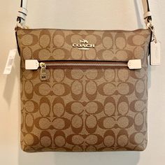 Brand New! Tags Included! The Coach Women's Rowan Top Zip File Crossbody Bag In Signature Canvas Is A Compact And Stylish Accessory. Made From Signature Coated Canvas And Smooth Leather, This Medium Sized Bag Includes An Inside Multifunction Pocket For Organization. The Bag Features A Zip-Top Closure With Fabric Lining For Secure Storage And An Outside Zip Pocket For Easy Access. The Adjustable Strap With A 22" Drop Allows For Shoulder Or Crossbody Wear. * Measures 10 1/4" (L) X 9 3/4" (H) X 1 1 Medium Sized Bags, Signature Canvas, Bag Set, Zip Top, Stylish Accessories, Zip File, Coach Bags, Smooth Leather, Easy Access