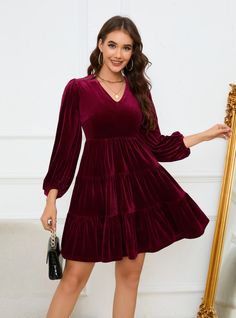 Light up your wardrobe with this charming burgundy velvet dress, designed to make you feel both elegant and comfortable. The dress features a flattering V-neckline and voluminous long sleeves, adding a touch of classic romance to its modern silhouette. The tiered skirt creates a playful yet sophisticated look, perfect for both casual outings and more formal events. Made from luxurious velvet fabric, this dress ensures you stay warm and stylish throughout the season. Pair it with ankle boots for a chic daytime look or with heels and statement jewelry for an evening out. This dress is a versatile addition to your wardrobe, offering endless styling possibilities and ensuring you look your best on any occasion. Velvet Short Dress, Velvet Dress Short, Burgundy Velvet Dress, Pleated Party Dress, Velvet Party Dress, Classic Romance, Backless Evening Dress, Sequined Dress, Lantern Sleeve Dress