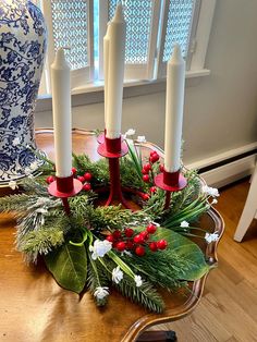 a christmas wreath on a table with candles