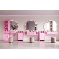 a pink vanity with two round mirrors and stools