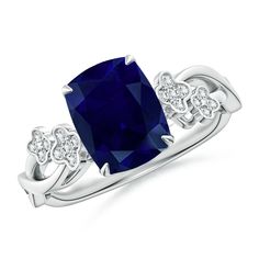 a ring with a blue stone and diamonds on the sides, set in white gold