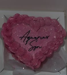 a pink heart shaped cake in a box with writing on the side and an angel's song written on it