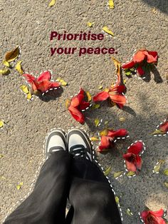 a person standing on the ground with flowers in front of them