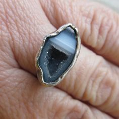 "Silver Mini Geode Ring Gray Druzy Ring Sparkly Druse Gemstone Ring: A stunning, one-of-a-kind, handmade stackable ring featuring a natural sparkling druzy geode set in sterling silver. The geode is gray and white and it measures 11/16\" by 7/16\". Band is 1/16\" wide. The ring itself is a size 6. Completely handmade by myself in sterling silver. Enter my shop: https://www.etsy.com/shop/artdi Join me on Facebook: https://www.facebook.com/Artdi-Diana-Anton-Jewelry-Design-44805607932/ Find me on I Spiritual Stackable Crystal Open Ring, Spiritual Stackable Open Crystal Ring, Spiritual Gemstone Rings For Jewelry Making, Open Crystal Ring With Stone Setting For Jewelry Making, Unique Stackable Crystal Ring As Gift, Unique Stackable Crystal Ring For Gift, Unique Stackable Open Crystal Ring, Spiritual Open Ring With Natural Stones, Unique Stackable Open Ring Jewelry