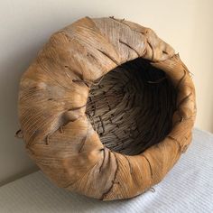 a wooden object sitting on top of a bed