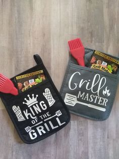 two oven mitts with grill master designs on them sitting on a wooden floor next to each other