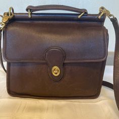 Fabulous Rare Vintage Coach Brown Leather Purse Early 1990’s. Good Condition For Its Age. Brass Hardware, Coach Tag, Removable, Adjustable 45” Strap Some Minor Flaws Due To Age. See Photos Approx 10” Wide, 9” Tall, 3.5 Wide 2 Outside Pockets And Inside Zipper Pocket Vintage Coach, Vintage Purse, Coach Bags, Zipper Pocket, See Photo, Leather Purses, Brown Leather, Bag Lady, Leather