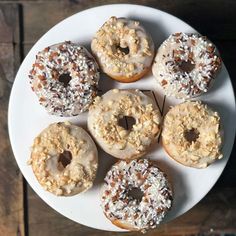 a white plate topped with donuts covered in frosting