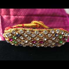 Flexible Gold Woven Thread Mesh Studded With Multicolored Stones With Velvet Back Traditional Design To Add That Extra Sparkle To Your Wrist . New Piece - Never Worn . Elegant Multicolor Festive Bracelets, Multicolor Bracelets For Formal Festivals, Multicolor Bracelets For Festivals And Formal Occasions, Multicolor Formal Bracelets For Festivals, Elegant Multicolor Bracelets For Festive Season, Jeweled Bracelets For Party And Festivals, Formal Multicolor Jeweled Bangle, Festive Jeweled Bracelets For Party, Adjustable Multicolor Bracelets For Festive Season