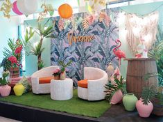 a room filled with lots of different types of plants and furniture on top of a green carpet