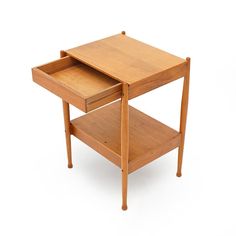 a small wooden table with one drawer open