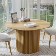 a wooden table with white chairs around it