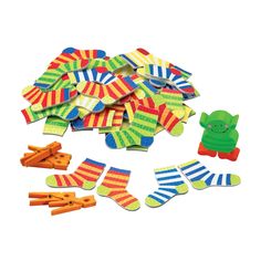 a pile of colorful socks and carrots next to each other