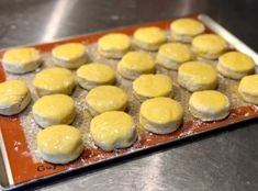 there are many doughnuts on the tray ready to be baked