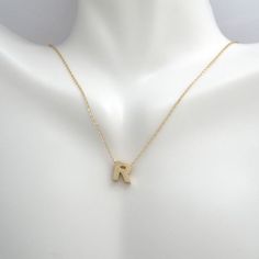 This pendant necklace is crafted in 14 Karat yellow gold. Featuring the letter "R" on a adjustable necklace measuring 16 or 18 inches in length. R Necklace, Initial R, R Letter, The Letter R, Letter R, Letter Pendants, Adjustable Necklace, Simple Necklace, Initial Necklace