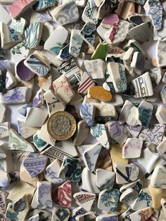 a pile of ceramic pieces with different designs on them