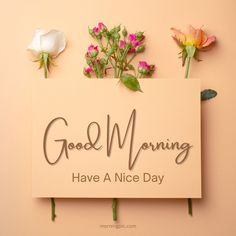 a sign that says good morning have a nice day with flowers on it and the words