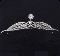 This tiara is beautifully silver-plated and encrusted with sparkling clear genuine zirconium stones of various sizes. The many zirconium Stones make this crown sparkle in any light and are prong set by hands! This piece is versatile and compliments many different styles, can be worn for Weddings, Bridal Showers, Birthdays, Baby Showers, Graduation, Maternity Shoots or any special occasions! Handmade Bridal Tiaras/Crown Made to Order Diamond Weight -- 10.24ct Diamond -- American Diamonds/Zircon D Elegant Crystal Crown Headpiece, Elegant Crystal Crown For Wedding, Elegant Crystal Headpieces For Weddings, Regal Tall Crown For Formal Occasions, Formal Tall Regal Crown, Elegant Silver Headpiece With Rhinestones, Silver Wedding Crown With Rhinestones, Silver Rhinestone Wedding Crown, Wedding Jewelry With High Crown And Crown Design