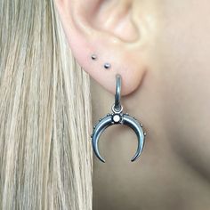 These Crescent Moon earrings are crafted with stainless steel and featuring a shiny black CZ stone, they are sure to make a statement. Sold as pair Material : 316 Stainless steel Hoop inner diameter: 10mm Hoop thickness: 2mm Hoop length:33 mm Post: regular 22 G Charm is removable Ships in a gift box Listing for Moon earrings only Pierced Stainless Steel Huggie Earrings, Hoop Metal Nose Rings, Pierced Huggie Stainless Steel Earrings, Pierced Huggie Earrings In Stainless Steel, Nickel-free Metal Piercings, Metal Crescent Hoop Earrings, Internally Threaded Metal Hoop Huggie Earrings, Pierced Round Metal Nose Rings, Pierced Metal Nose Rings