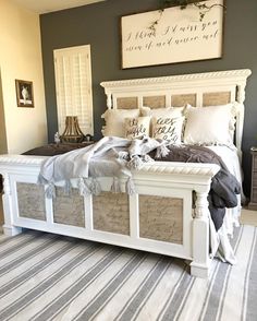 a white bed sitting in a bedroom on top of a rug